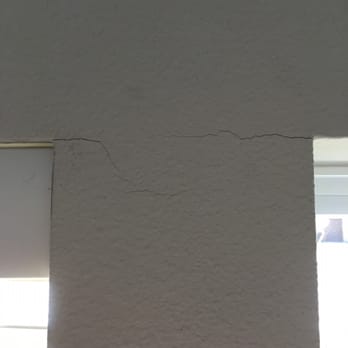 Blind Faith - Cracking caused by Blind Faiths poor installation (lack of drilling a starter hole).  The blind on the right side was installed and removed. - Shades & Blinds Near Me - Cedar Park, Texas