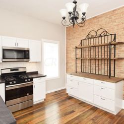 Remodelorz - Exposed brick, custom made shelving, refinished floors.