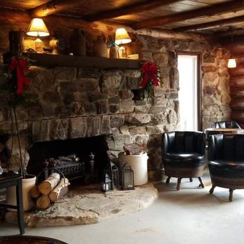 Chadwick's Craft Spirits - a living room with a stone fireplace - Distilleries Near Me - Pittston, Maine