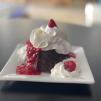 Reeds Bar and Grill - a chocolate cake with whipped cream and raspberry sauce - Chicken Wings Near Me - Monroeville, Alabama