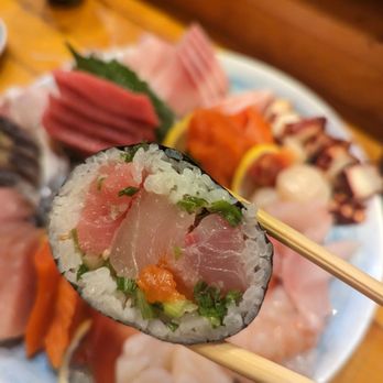 Toyoda Sushi - a plate of sushi with chopsticks - Sushi Bars Near Me - Seattle, Washington