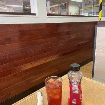 Linthicum Luncheteria - a table with a drink and a shaker - American Near Me - Linthicum, Maryland
