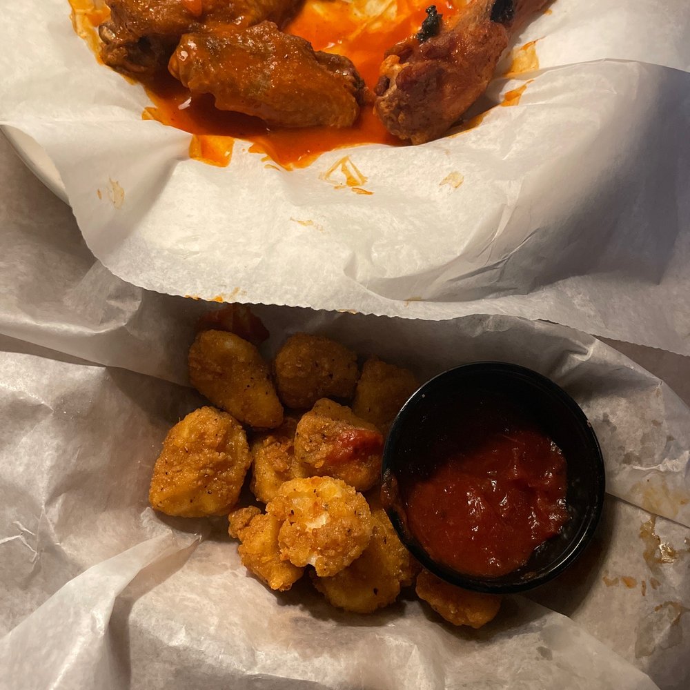 a basket of chicken wings and dipping sauce a basket of chicken wings and dipping sauce