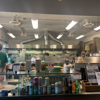 Pagliacci Pizza - a man preparing food in a restaurant - Pizza Near Me - Seattle, Washington