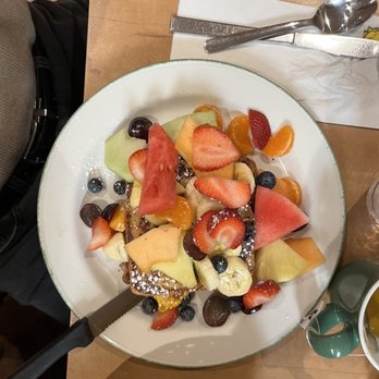 Cora - a bowl of fruit and a plate of bread - Breakfast & Brunch Near Me - Montreal, Quebec