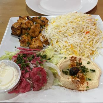 Taj Ali - #10 chicken tikka over rice. Addition of garlic sauce. - Middle Eastern Near Me - Lincoln, Nebraska Taj Ali - #10 chicken tikka over rice. Addition of garlic sauce. - Middle Eastern Near Me - Lincoln, Nebraska