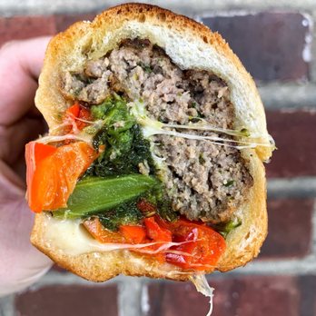Vincenzo's Deli - a hand holding a sandwich - Delis Near Me - Philadelphia, Pennsylvania