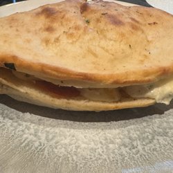 American Pie Pizzeria - Ordered a Calzone with pepperoni. They didn't make a fresh one. They just cut open a pre cooked one and added pepperoni.