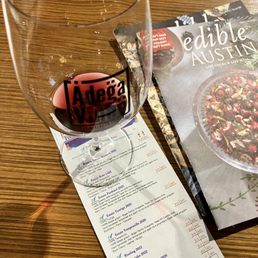 a menu and a glass of wine a menu and a glass of wine