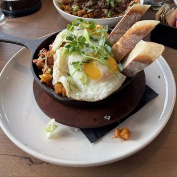 Mendon Brunch On The Brook - The Skillet: Raw fried potatoes, Aged chorizo, Queso chihuahua, Avocado, Sunny eggs, Baguette - Coffee & Tea Near Me - Mendon, New York Mendon Brunch On The Brook - The Skillet: Raw fried potatoes, Aged chorizo, Queso chihuahua, Avocado, Sunny eggs, Baguette - Coffee & Tea Near Me - Mendon, New York