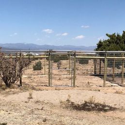 Chicken yard fence with coyote rollers and welded wire mesh skirt