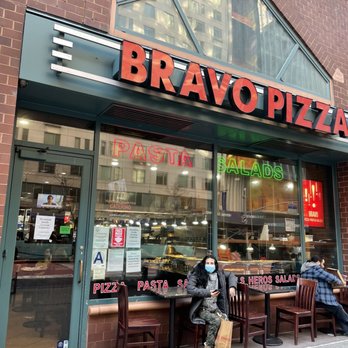 Bravo Pizza - people sitting at tables outside a restaurant - Pizza Near Me - New York, New York