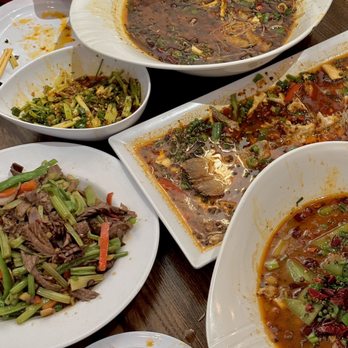 Xu Chu - a variety of dishes of food on a table - Chinese Near Me - Queens, New York