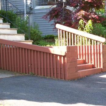 Design by Lee Landscaping - a red railing and steps leading to a house - Landscaping Near Me - Mauldin, South Carolina Design by Lee Landscaping - a red railing and steps leading to a house - Landscaping Near Me - Mauldin, South Carolina