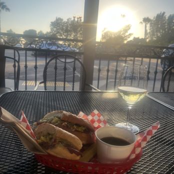 OC Wine Mart & Deli - Pastrami sandwich with a pickle and side of aju for dipping  #8and small glass of wine - Wine Bars Near Me - Orange, California