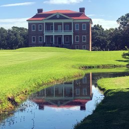 A view of the house including the reflective pond.