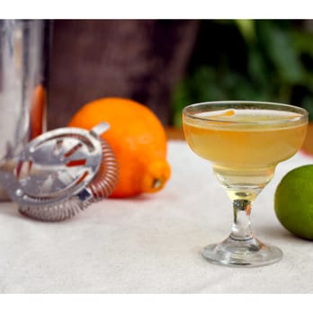 Florida Cookery - a cocktail in a coupe glass with a lime - New American Near Me - Miami Beach, Florida Florida Cookery - a cocktail in a coupe glass with a lime - New American Near Me - Miami Beach, Florida