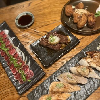 Kintaro Izakaya - Left: Gyu tataki Right: aburi sushi Middle: beef tenderloin skewers Back: oysters karaage - Japanese Near Me - Toronto, Ontario Kintaro Izakaya - Left: Gyu tataki Right: aburi sushi Middle: beef tenderloin skewers Back: oysters karaage - Japanese Near Me - Toronto, Ontario
