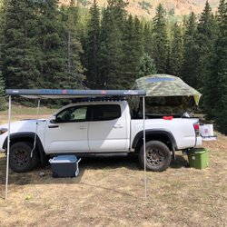 Storm Trooper Tacoma loaded with a Rhino-Rack rack system, Thule awning, Yakima rooftop tent, RoadShower, and more.