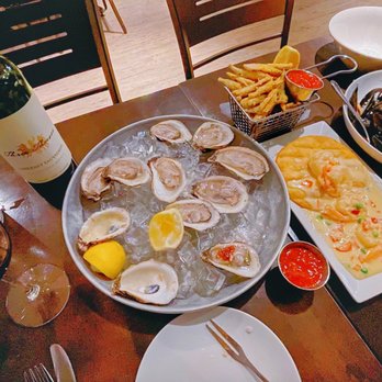 Seafood Grill - a table full of food and wine - Seafood Near Me - Nepean, Ontario Seafood Grill - a table full of food and wine - Seafood Near Me - Nepean, Ontario