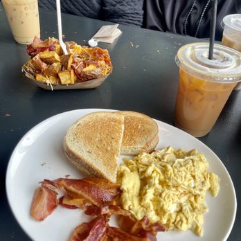 Perch - Eggs, bacon, and rye bread with iced coffee. And then a spud bowl in the back with bacons/cheese - New American Near Me - Lehighton, Pennsylvania