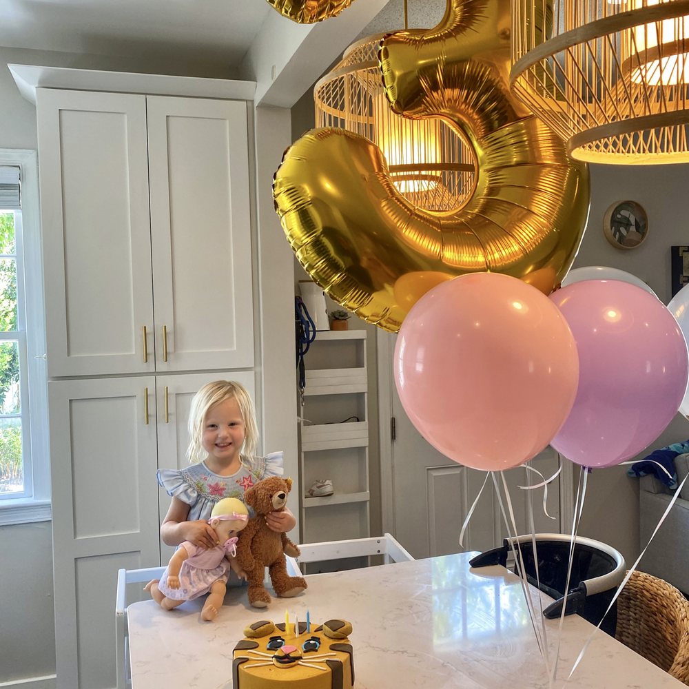 Wildflour Pastry - a little girl sitting in front of a birthday cake - Desserts Near Me - Charleston, South Carolina