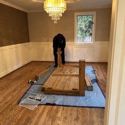 Assembly of dinning table, all parts attached, brand new hardwood floors protected. Assembly of dinning table, all parts attached, brand new hardwood floors protected.