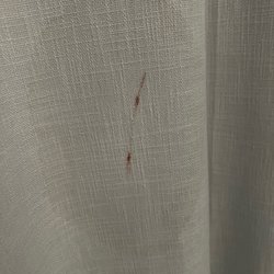 Surfside Properties - Stain on curtain in guest bedroom