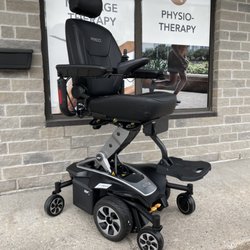 Houle Healthcare - Pride mobility jazzy 2 power wheelchair in black in an elevated position that helps people reach high places