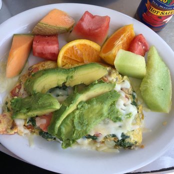 The Small Café - Farmers market omelette topped with avocado and a side of fruit. - Breakfast & Brunch Near Me - Long Beach, California The Small Café - Farmers market omelette topped with avocado and a side of fruit. - Breakfast & Brunch Near Me - Long Beach, California