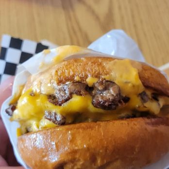 Glow Juice Bar -  hand holding a cheeseburger - Juice Bars & Smoothies Near Me - Oakhurst, California