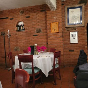 Manducatis - a table and chairs in a restaurant - Italian Near Me - Long Island City, New York Manducatis - a table and chairs in a restaurant - Italian Near Me - Long Island City, New York