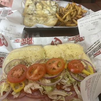 Penn Station East Coast Subs - Cold Italian sub and background is an artichoke sandwhich - New American Near Me - Suwanee, Georgia Penn Station East Coast Subs - Cold Italian sub and background is an artichoke sandwhich - New American Near Me - Suwanee, Georgia