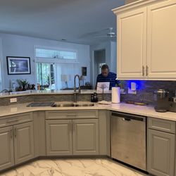 American Wood Reface - This is after. New refacing with grey lowers and cream white uppers. Cabinet design is also slightly different.