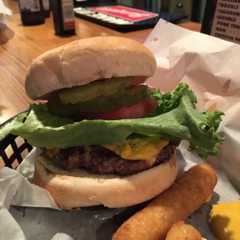 B Hive - a hamburger with lettuce, tomato, pickles, and cheese - Bars Near Me - Colby, Kansas