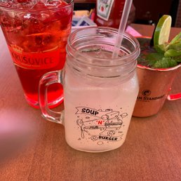 a mason jar with a drink in it a mason jar with a drink in it