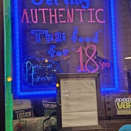 The very bright signs in the window of the restaurant. The very bright signs in the window of the restaurant.