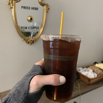 Hanna Bee Coffee - a hand holding a cup of iced coffee - Coffee & Tea Near Me - Nashville, Tennessee