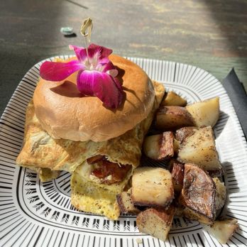 Luna Muna Cafe Bar - Bacon, egg, & Gouda bagel with potatoes - Breakfast & Brunch Near Me - Panama City, Florida Luna Muna Cafe Bar - Bacon, egg, & Gouda bagel with potatoes - Breakfast & Brunch Near Me - Panama City, Florida