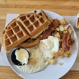 Waffle, eggs, bacon and potatoes