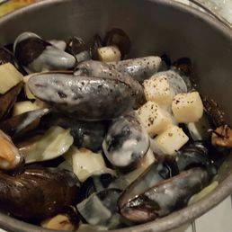 Big pot of mussels with cheese.