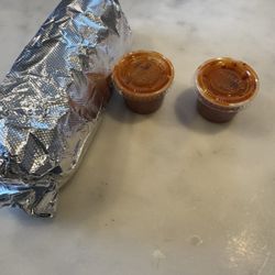 Cocina Mariposa - Breakfast burrito hold the meat with two hot sauces.