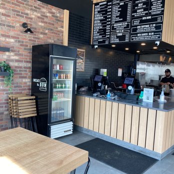 Meat The Bun - a restaurant counter with a menu on the wall - Burgers Near Me - Edmonton, Alberta Meat The Bun - a restaurant counter with a menu on the wall - Burgers Near Me - Edmonton, Alberta