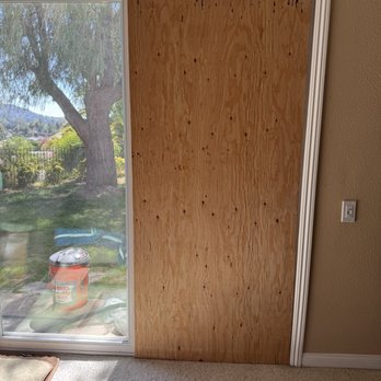 Fast Quality Service - Dual plywood panel to temporarily repair the sliding glass door until new glass arrives - Handyman Near Me