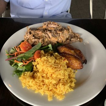 Sofrito Latin Cafe - Very tender pork with yellow rice, salad and plantains - Latin American Near Me - Orlando, Florida Sofrito Latin Cafe - Very tender pork with yellow rice, salad and plantains - Latin American Near Me - Orlando, Florida