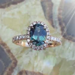 Paul-Randolph Jewellers - High quality oval teal sapphire in a custom made rose gold halo setting with diamonds