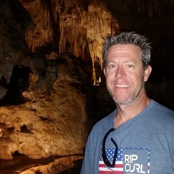 Golden Flooring - a man holding a water bottle in a cave - Flooring Near Me - Ventura, California Golden Flooring - a man holding a water bottle in a cave - Flooring Near Me - Ventura, California