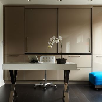 Spogue Kitchens & Bath - Spogue's modern storage cabinet solution in truffle grey gloss lacquer highlighted with stainless steel pulls - Interior Design Near Me - Wayne, Pennsylvania Spogue Kitchens & Bath - Spogue's modern storage cabinet solution in truffle grey gloss lacquer highlighted with stainless steel pulls - Interior Design Near Me - Wayne, Pennsylvania
