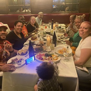 American Prime - a group of people sitting at a table - Steakhouses Near Me - Rye Brook, New York