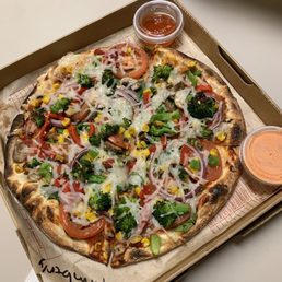 MOD-sized pizza with red sauce, dairy-free cheese, double veggies, and Mike's Hot Honey Sauce and SriRancha Sauce (both on the side)